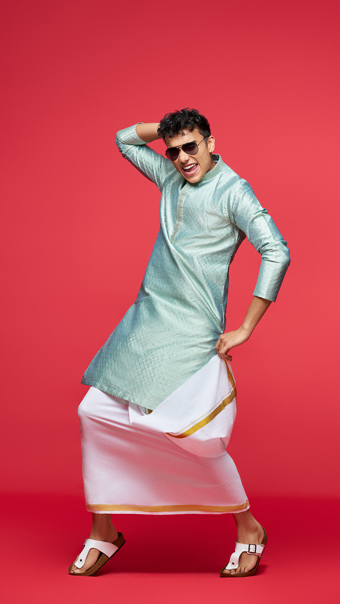 Man in a mint green kurta demonstrates a versatile ready-made fit, offering comfort and style across body types.